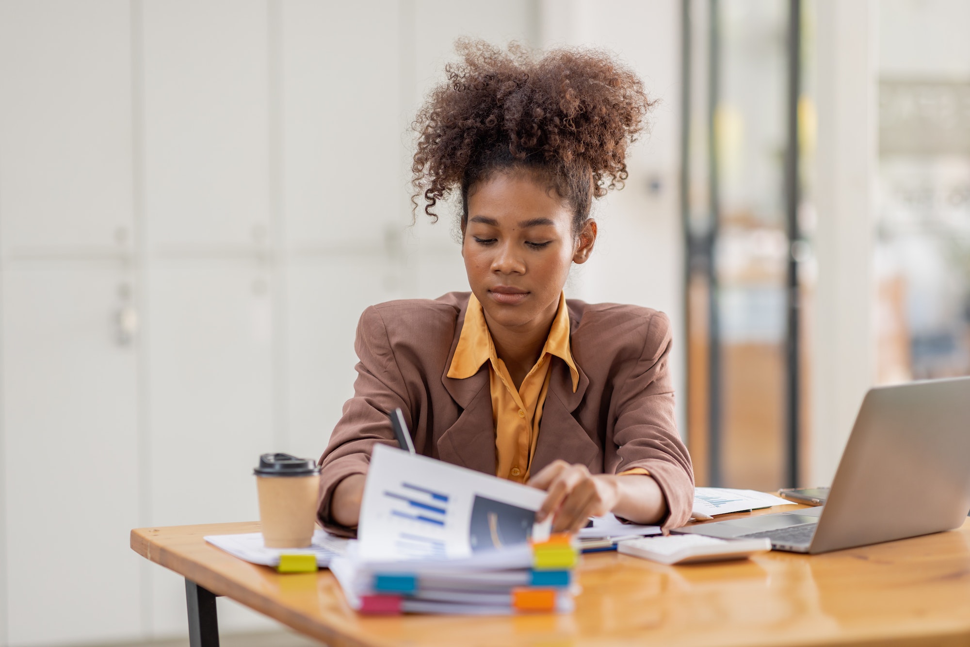 businesswoman analyzing statistics on laptop screen, working with financial graphs charts online,