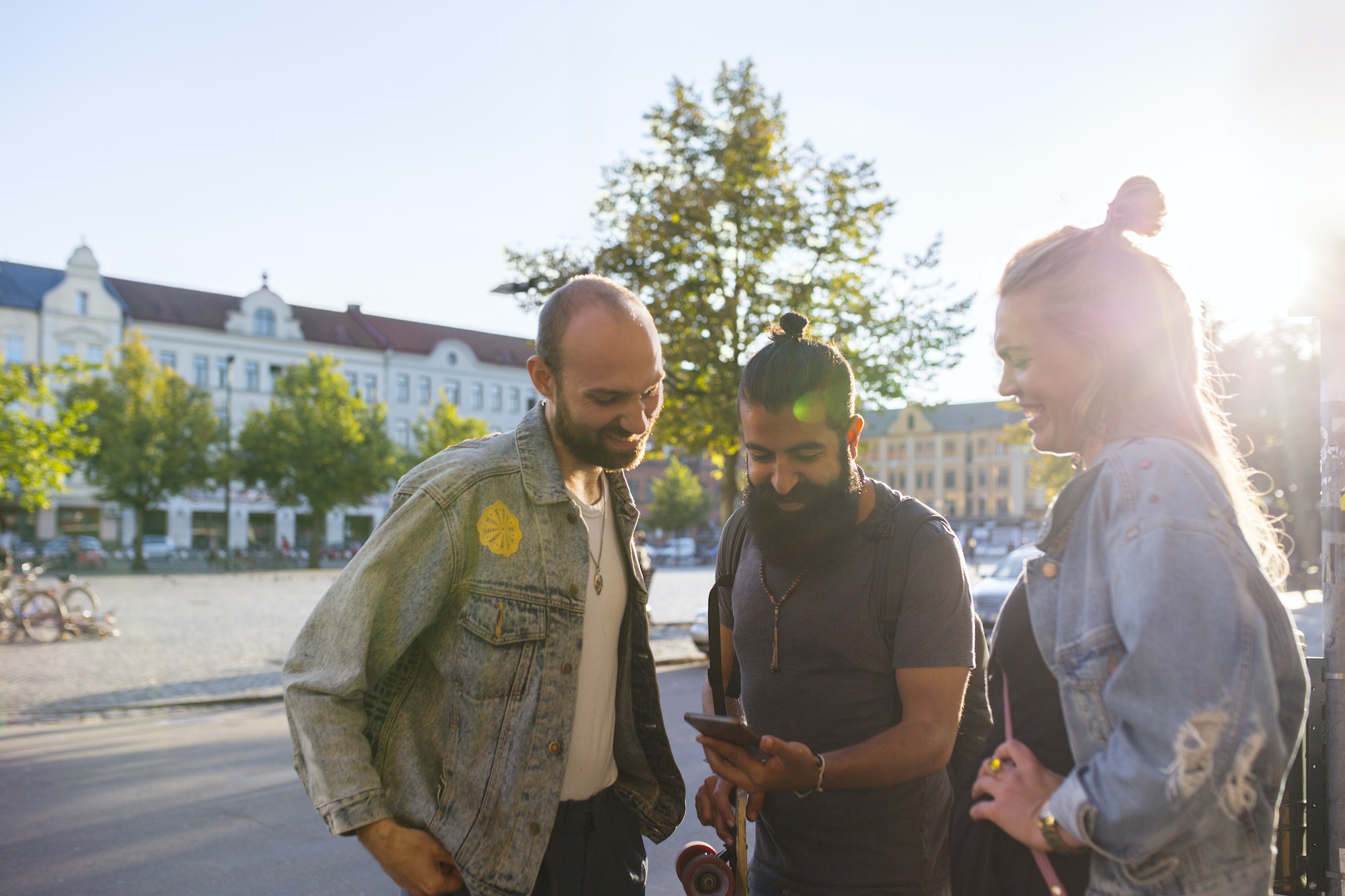 Three friends looking at smartphone