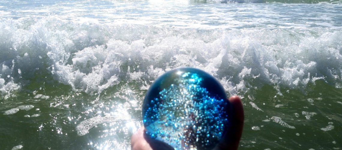 A blue crystal ball with bubbles forecasts many more ocean waves in the future.