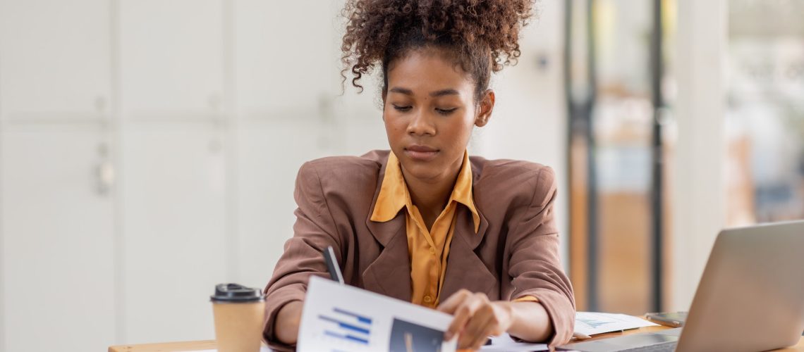 businesswoman analyzing statistics on laptop screen, working with financial graphs charts online,