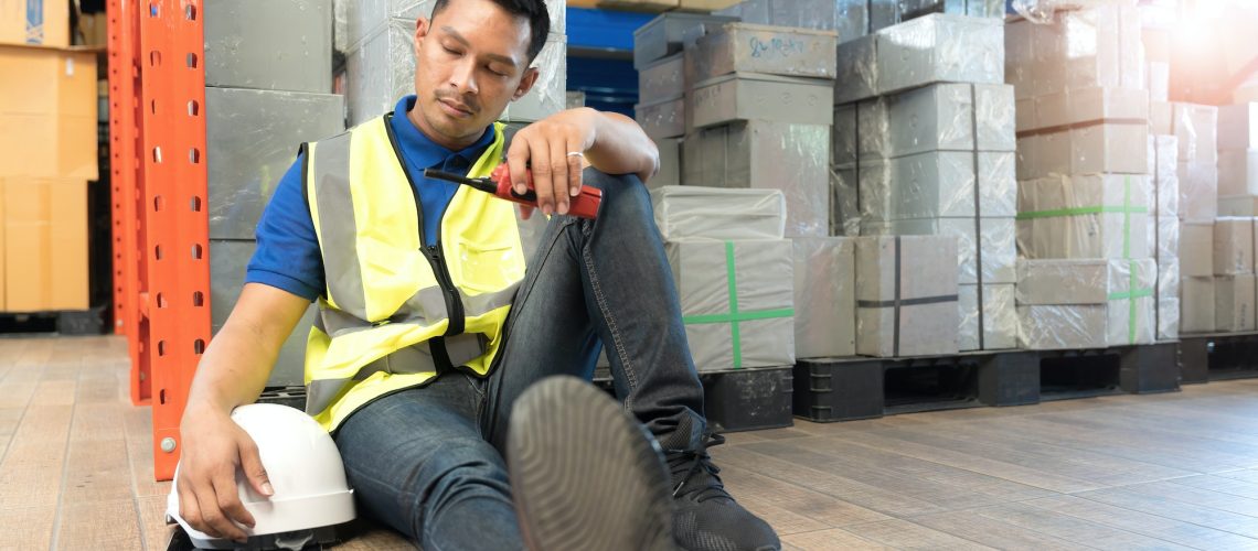 logistic worker man stress sit in warehouses worried, exhausted from overwork and cheap wages as the