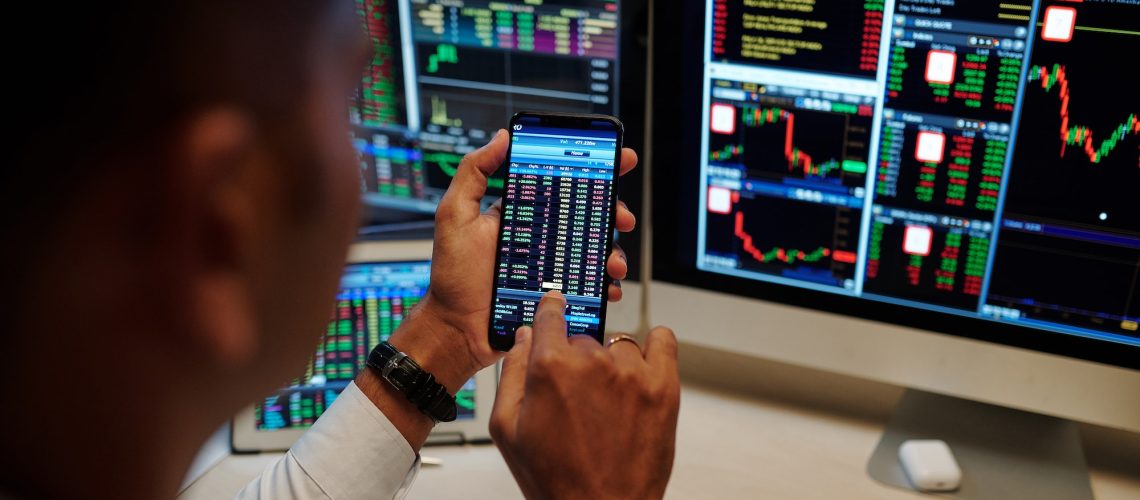 Man trading stocks via application