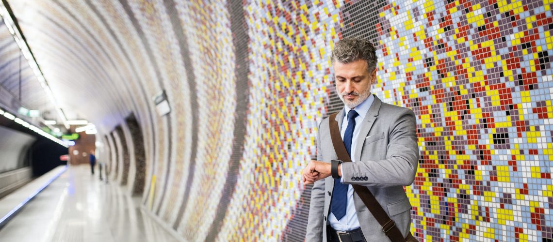 Mature businessman waiting on a metro station.