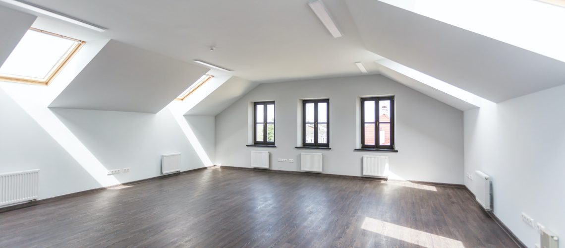 Side view of unfurnished room interior with wooden floor on roof floor, white walls